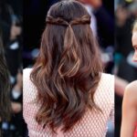Close-up of hands styling an elegant updo hairstyle for a wedding in New York home setting